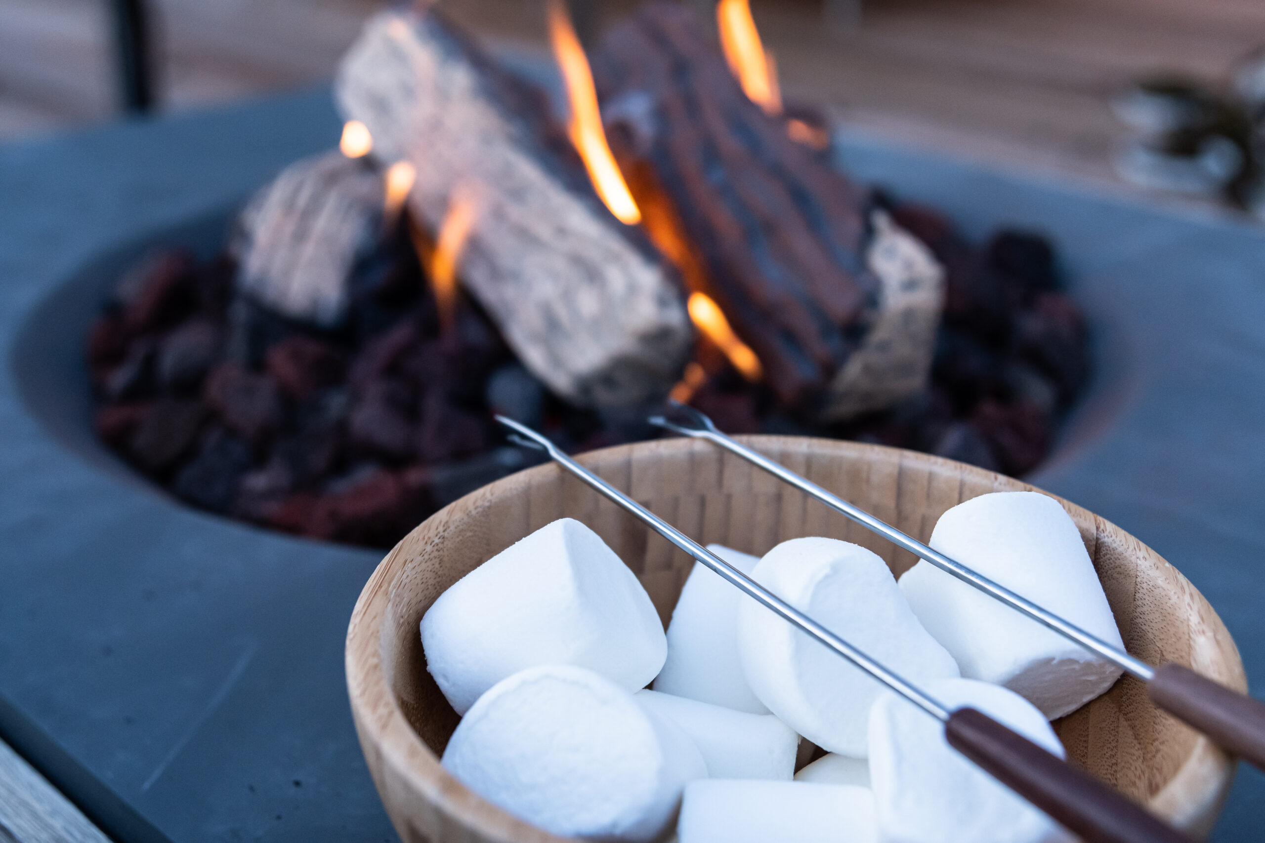 Roasting marshmallow over a gas fire while glamping